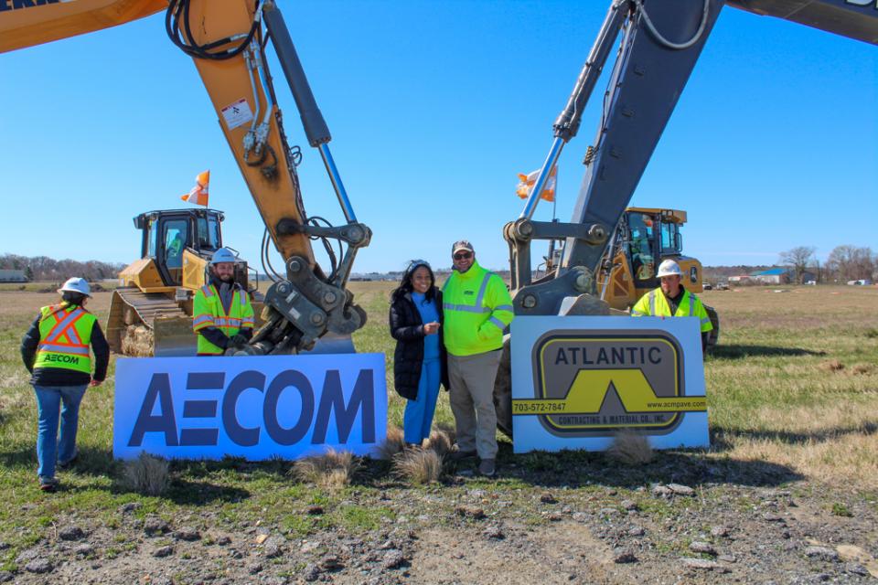 Micah Risher, Easton Airport Manager, and Assistant Secretary Greene stand with AECOM and Atlantic Contracting &amp; Materials employees.