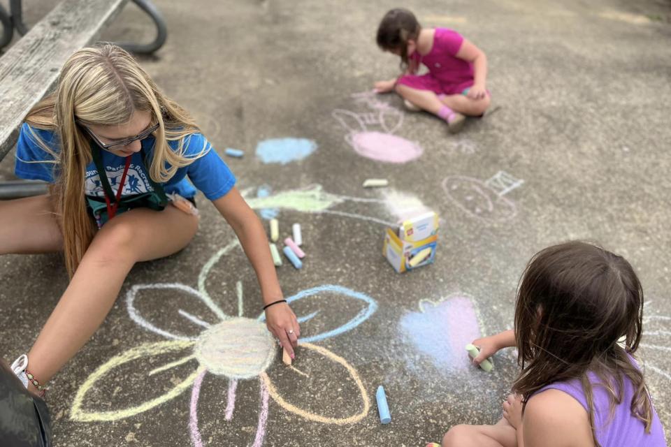 Campers and Counselor create chalk drawings during Talbot County Parks and Recreation Summer Camp.