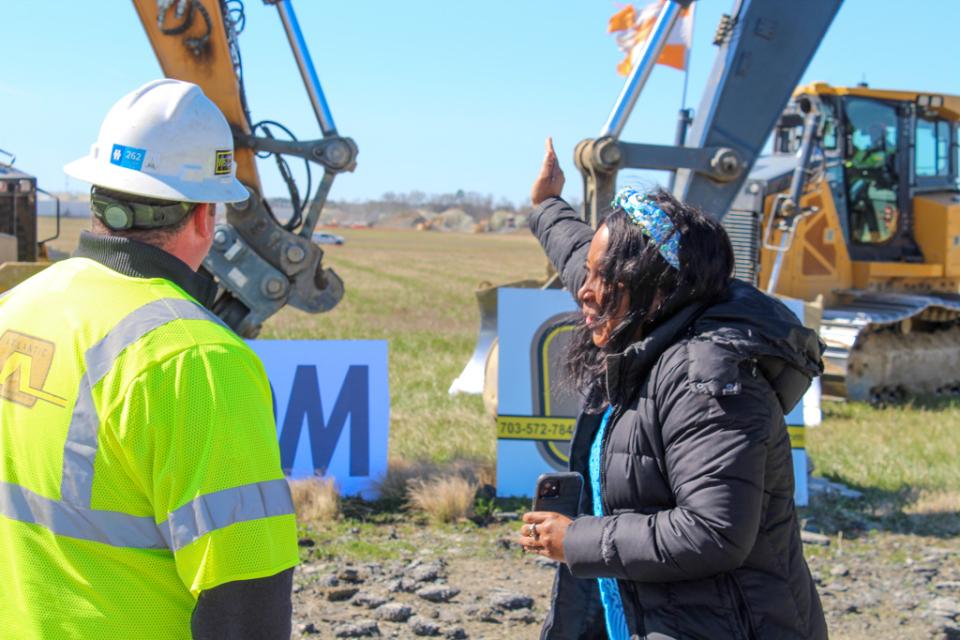 As.Secretary Greene indicates where the runway will extend to with Project Manager, Lynn Kenney. Dirt piles can be seen in the distance that will be used to level the surface to appropriate height.