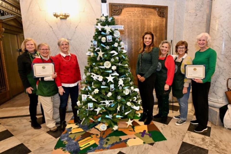 Members of the Talbot County Garden Club and the Oxford Garden Club with Maryland&#039;s First Lady Dawn Moore around the Easton Airport 80th Themed Tree at the State Capitol Rotunda.